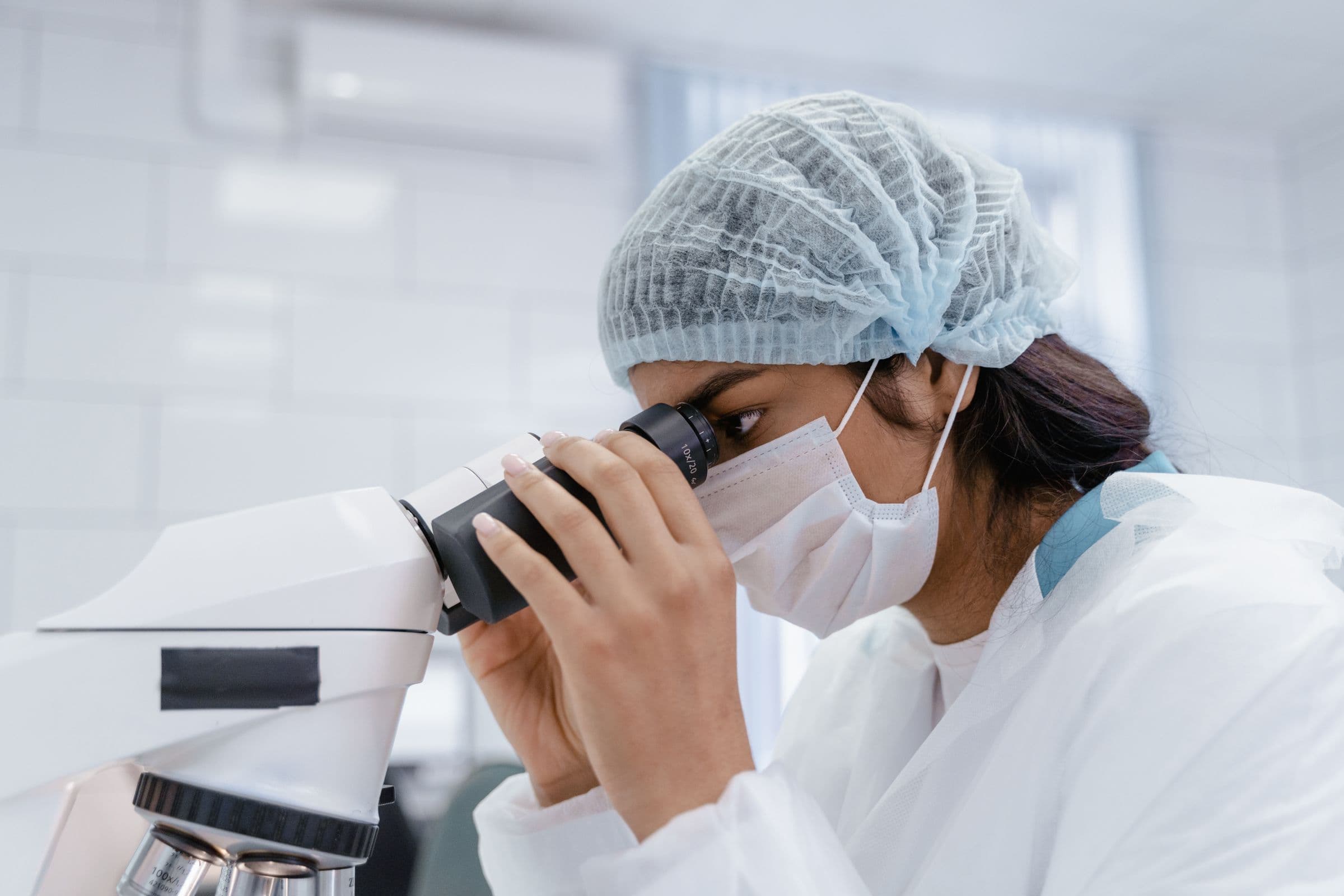 Scientist looking through a microscope