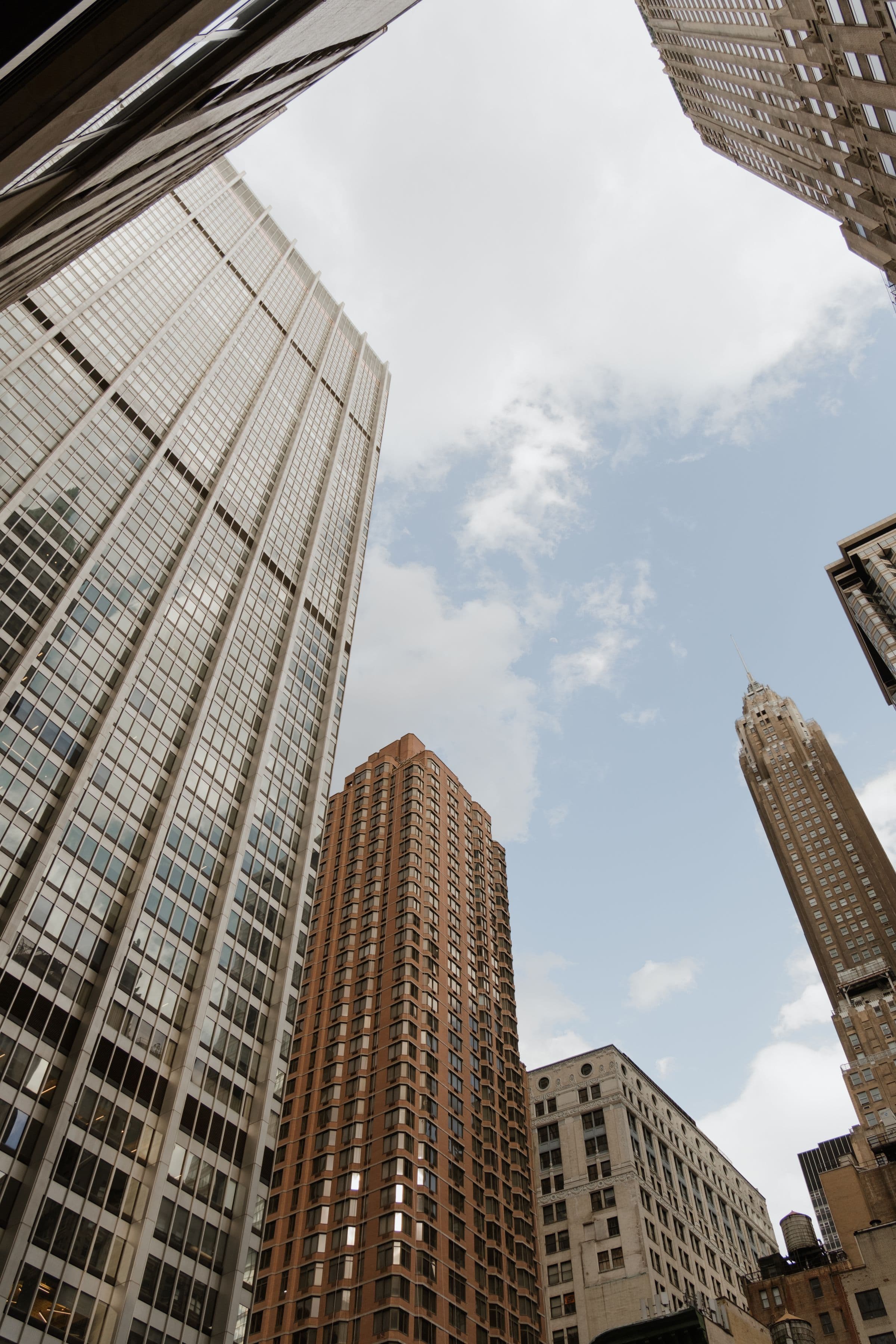 City skyline reflected across a glass tower