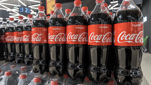 Coca-Cola bottles in a refrigerated case