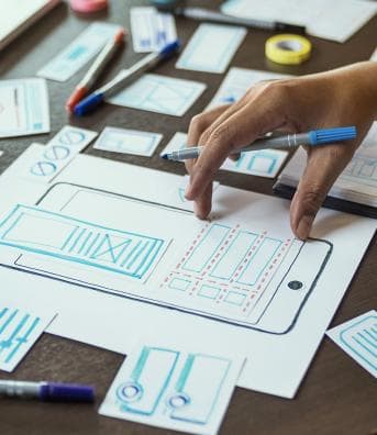 Hands reviewing plans on a tablet
