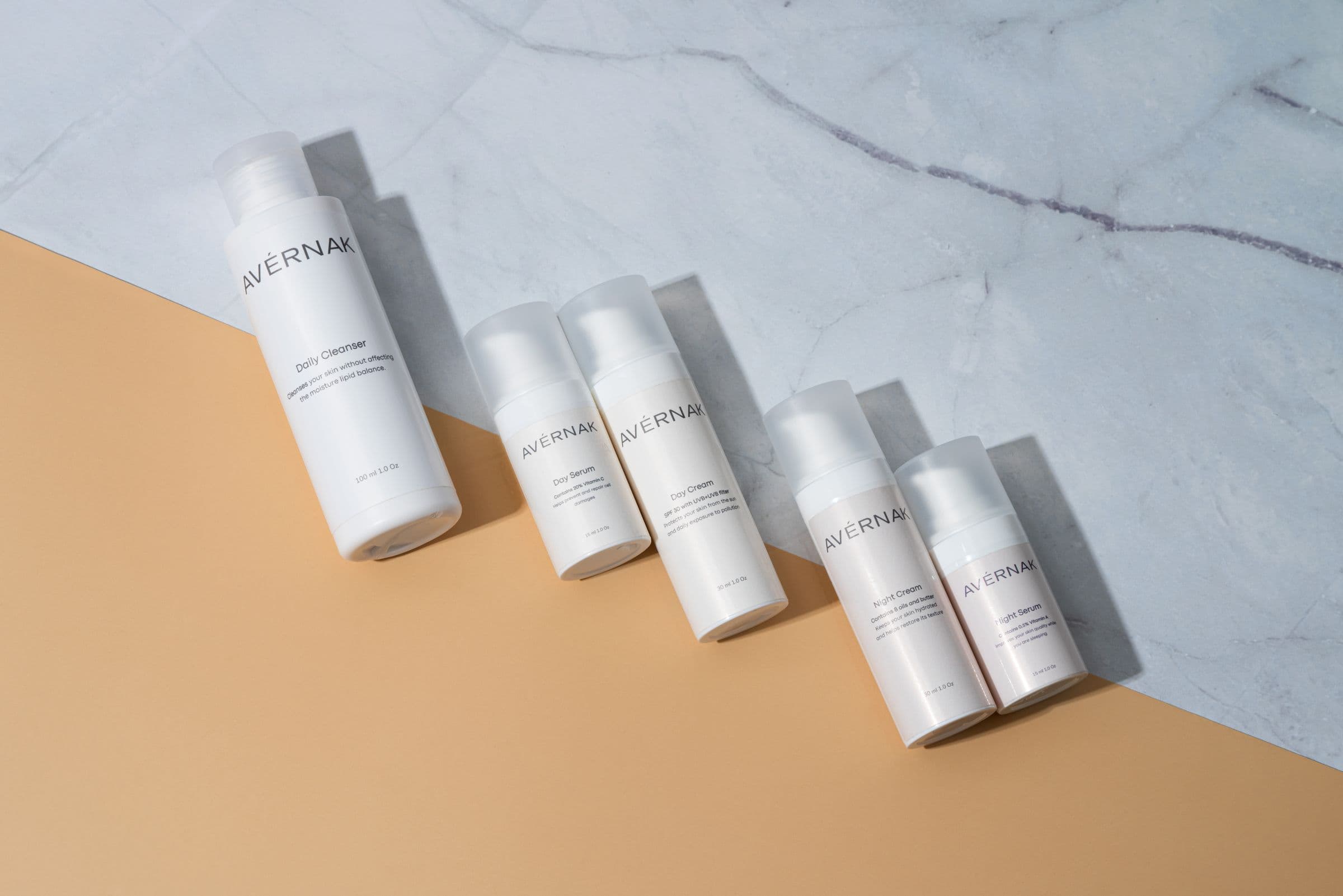 White cosmetic bottles on a stone surface