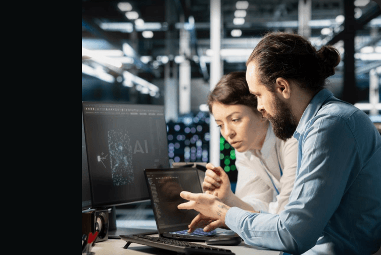 Two people reviewing an AI workflow on a laptop